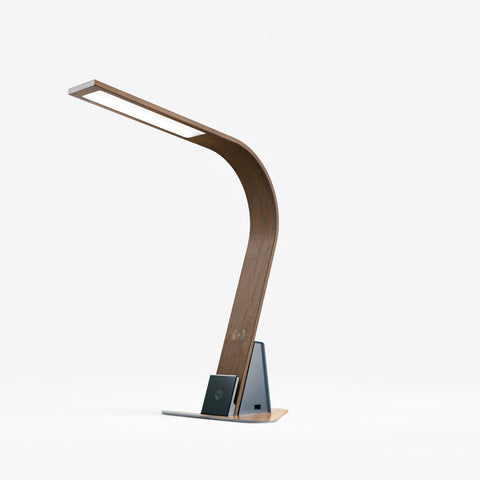 The Brooklyn Aura LED Task Lamp in Black Walnut Finish with a stabilizing base, on a white background. The USB-C port is shown, along with the 12W Qi Wireless Charging Pad and Touch-Dimmable power button. The USB-A port is on the other side of the lamp.