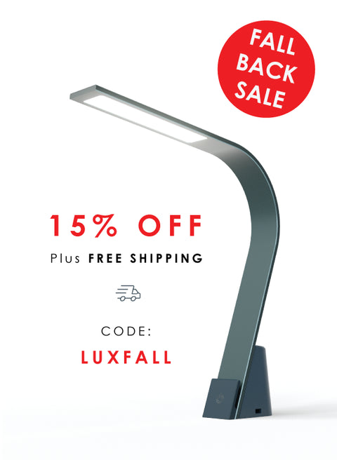 Modern LED Task lamp on a white background with promotional text about a 15% off Fall Back Sale with promo code LUXFALL