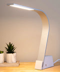 Brooklyn AC LED Task Lamp in brushed aluminum finish, placed on a wooden desk in a minimalist office setting