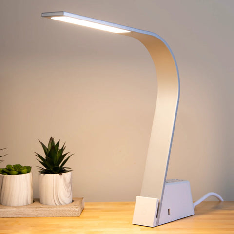 Brooklyn AC LED Task Lamp in brushed aluminum finish, placed on a wooden desk in a minimalist office setting