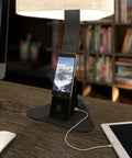 Brooklyn Aura LED Desk Lamp charging a smart phone on the 12 Watt Wireless Qi Charging Pad.There is also an iPad plugged into the USB-C port.