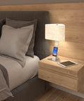 Brooklyn LED Desk Light charging a smartphone and an ipad on a bedside table