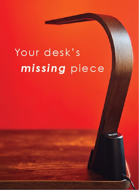LUX Brooklyn LED Task lamp with Black Walnut finish on a wooden desk. Text reads "Your desk's missing piece."