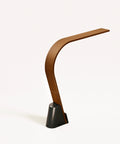 A rear view of the modern wooden Brooklyn USB LED Task Lamp in Black Walnut finish, with USB charging on a white background