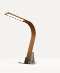 Brooklyn Aura Task Lamp in Black Walnut Finish with the optional stabilizing base on a White Background. The Touch activated dimmer, Qi Wireless Charging Pad, and USB ports are showing.