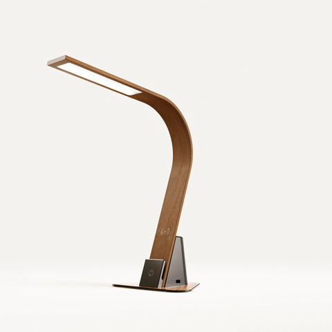 Brooklyn Aura Task Lamp in Black Walnut Finish with the optional stabilizing base on a White Background. The Touch activated dimmer, Qi Wireless Charging Pad, and USB ports are showing.