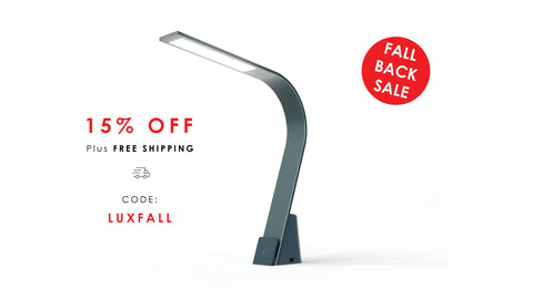 Modern LED Task lamp on a white background with promotional text about a 15% off Fall Back Sale with promo code LUXFALL