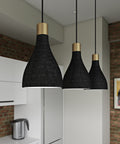 Close up of three charcoal La Brea LED pendant lights hanging in a brick kitchen