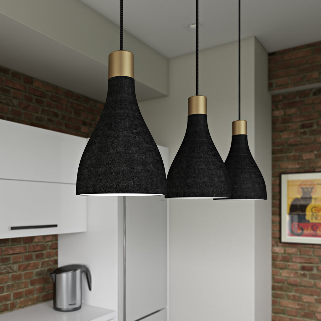 Close up of three charcoal La Brea LED pendant lights hanging in a brick kitchen