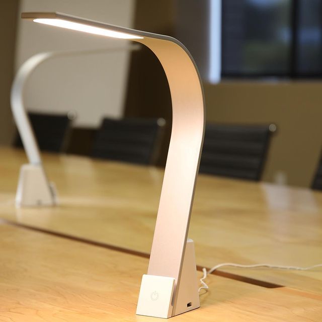 A LUX LED task light on a conference room table.
