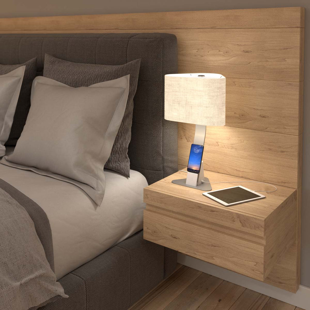 Brooklyn LED Desk Light charging a smartphone and an ipad on a bedside table