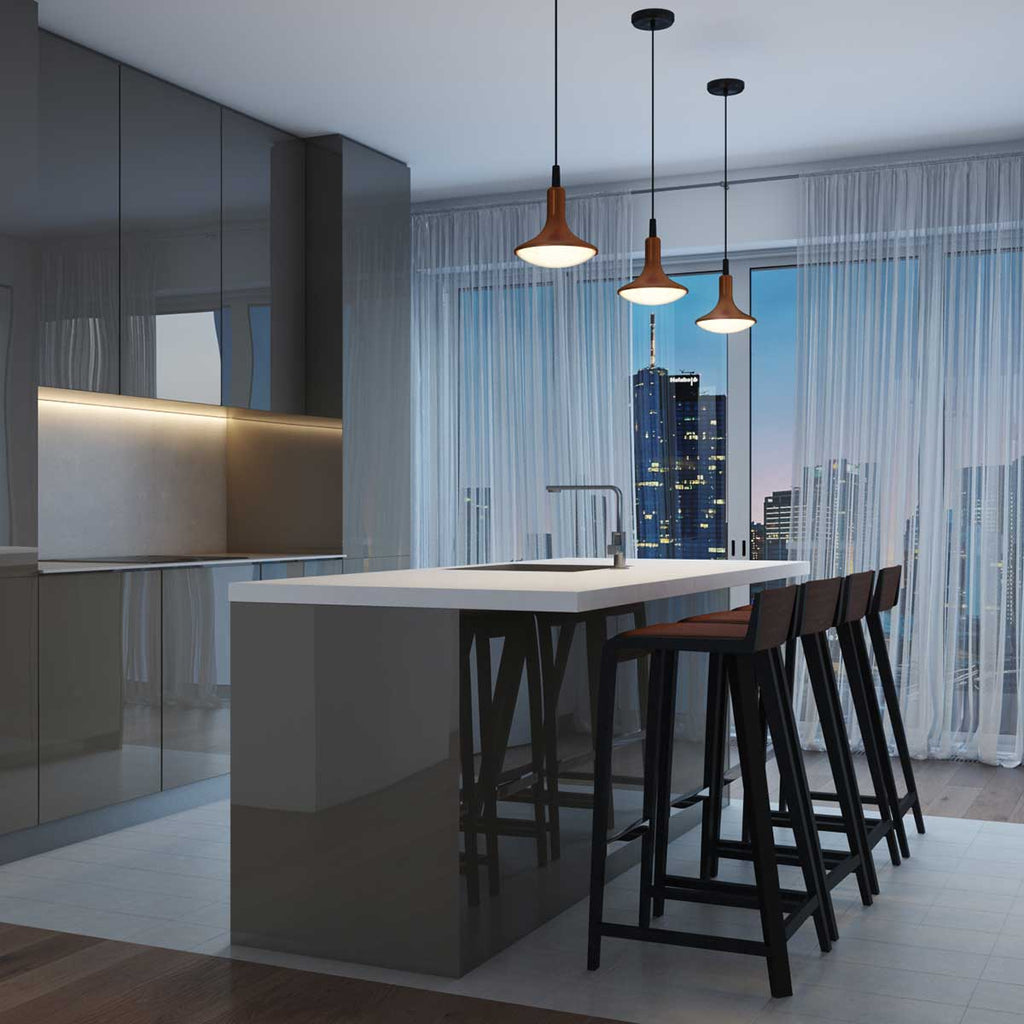 Three copper droplet LED pendant lights hanging over a high top kitchen counter overlooking the city
