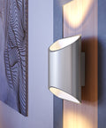 Close view of a brushed aluminum Brooklyn LED wall sconce mounted on a wall