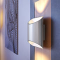 Close view of a brushed aluminum Brooklyn LED wall sconce mounted on a wall