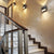 Three black slate Brooklyn LED wall sconces mounted in the stair case of a home 