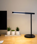 Highline USB LED Desk Lamp on a desk with warm upward and downward illumination