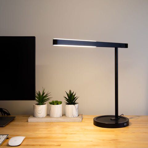 Highline USB LED Desk Lamp on a desk with warm upward and downward illumination